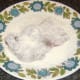 Ox liver is patted in seasoned flour.