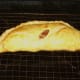 Spicy corned beef and cabbage pasty resting on wire rack