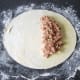 Pasty filling is arranged on half the pastry circle