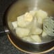 Mashing potatoes with butter and white pepper