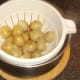 Draining boiled new potato halves