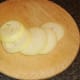 Peeled onion is sliced for making onion rings