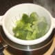 Poached broccoli florets are drained