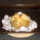 Spicy cheese is melted in to baked potato