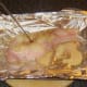 Testing baked back bacon steak for doneness