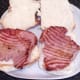 Gammon steaks are laid on bottom halves of bread rolls