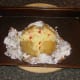 Spicy cheddar cheese added to baked potato