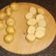 New potatoes are halved before being boiled