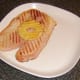 Griddled pineapple ring is sat on gammon steak
