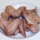 Roast chicken wings are left to rest and cool