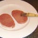 Bacon steaks are oiled for griddling