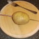 Potato is skewered for baking and pierced with fork