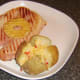 Spicy cheese baked potato is plated with gammon steak and pineapple