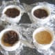 Christmas pudding is spooned on to set biscuit crumb cheesecake base