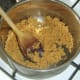Biscuit crumb is stirred in to melted butter