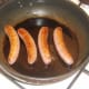 Sausages are gently fried in oil