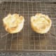 Christmas pudding pies are rested on wire rack
