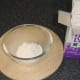 Icing sugar is prepared for topping Christmas pudding pies