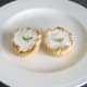 A small sprig of fresh mint garnishes each iced Christmas pudding pie