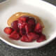 Stewed plums are spooned over Christmas pudding pancakes
