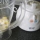 Preparing to blend pineapple and cheese