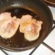 Middle bacon is fried in pan vacated by sausages