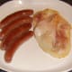 Sausages and bacon are plated