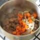 Chopped carrot and onion added to browned beef