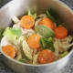 Conger eel poaching accompaniments are added to pot