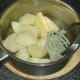 Mashing boiled potatoes