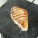 Pork chop is turned in griddle pan