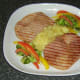 Apple and pineapple sauce is plated with gammon steaks