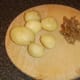 Boiled and cooled potatoes are peeled for deep frying