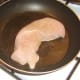 Starting to fry seasoned turkey breast fillet