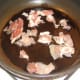 Satrting to sauté chopped bacon
