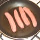 Starting to fry sausages