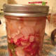 Wipe the rim of the jar with a damp paper towel to get rid of anything that may have spilled. Since we aren't waterbath or pressure canning these, it's more for cleanliness than anything else. Put the lid and ring on the jar.