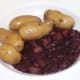 New potatoes are plated with autruche au vin