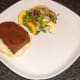 Ostrich steak is laid on bottom half of bread roll
