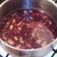 Red wine added to vegetables and bacon