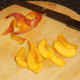 Peach half is peeled and sliced