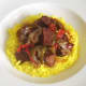 Ostrich casserole is spooned on to spicy rice bed