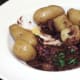 Enjoying autruche au vin with new potatoes