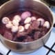 Shallots, mushrooms and browned ostrich meat added to red wine, vegetables and bacon