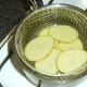Preparing to parboil potato slices