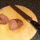 Rested ostrich steak is halved