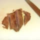 Griddled and rested ostrich steak is sliced