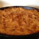 To brown the top, return the uncovered macaroni and cheese to the oven for approximately 15 more minutes.