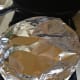 Cover with aluminum foil or a lid if your pan has one. Put the macaroni and cheese into the oven.