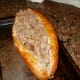 Spoon meat, mushroom, and cheese mixture into hoagie rolls.